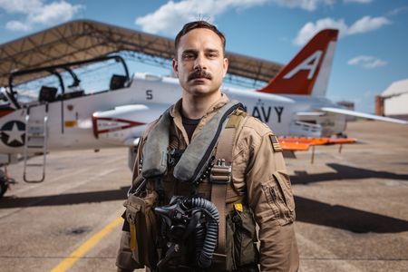 Student LTJG Spenser Neel poses alongside a T-45. (National Geographic/Freddie Claire)