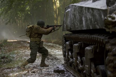 E.G. McConnell (played by Rufus Shutter) aims his weapon while standing near his tank in a historic reenactment of the Battle of the Bulge produced for "Erased: WW2's Heroes of Color." Private First Class E.G. McConnell served with the 761st Black Panther Tank Battalion in WW2. (National Geographic/Rekha Garton)