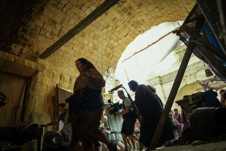 Director of Photography Jim Jolliffe runs with a camera rig amongst fleeing citizens of Pompeii, behind-the-scenes of Pompeii: Out of Time with Tom Hiddleston. (National Geographic/Darrin Zammit Lupi)