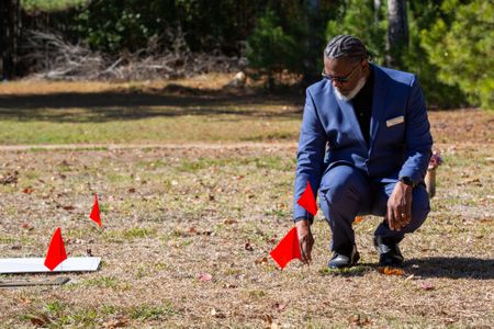Funeral Home Manager Randolph Taylor flags Fulton County John Doe David Brown's unmarked grave, ready for his family to visit for the first time. (National Geographic/Tom Beard)