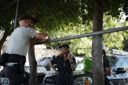 The crew talks near a fence with Mariana van Zeller. (National Geographic)