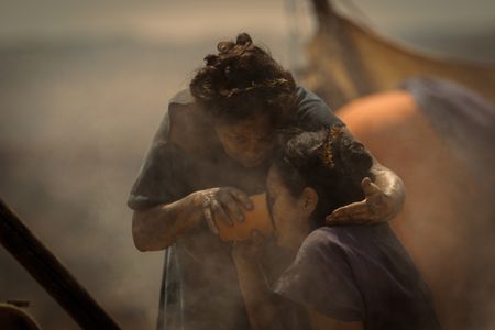 An elderly woman helps an injured woman drink water at the Pompeii displacement camp.(National Geographic/Darrin Zammit Lupi)