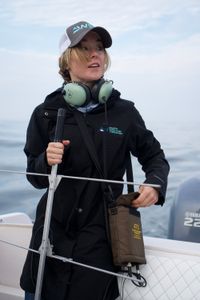 Dr. Megan Winton stands holding the VHF receiver. (National Geographic/Brandon Sargeant)