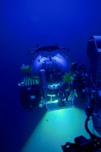 Crew Mario Tadinac, Dave Pollock, and David Reichert sitting inside the submarine floating in water.  (National Geographic/Mario Tadinac)