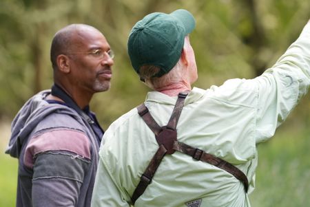 Christian Cooper listens to biologist Steve Kendall at Hakalau Forest National Wildlife Refuge. (National Geographic for Disney/Troy Christopher)