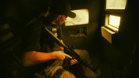 Dewald Pieterse guards a cash-in-transit truck with a gun in Johannesburg, South Africa. (National Geographic)