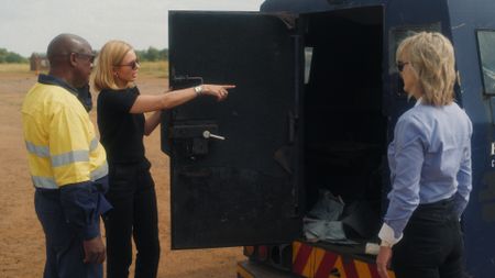 Isaac Ramashepa, Nadine Rynners, and Mariana van Zeller look inside of a cash-in-transit truck that they are going to test in Johannesburg, South Africa. (National Geographic)