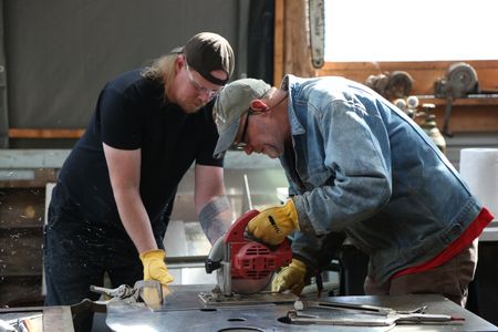 David Squibb and Sam Carlson construct a new fairlead for Squibb's skiff. (National Geographic/Wayne Moss)