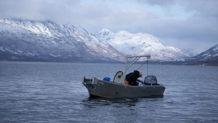 Marvin Agnot sets crab pots in the water. (National Geographic/Ashton Hurlburt)