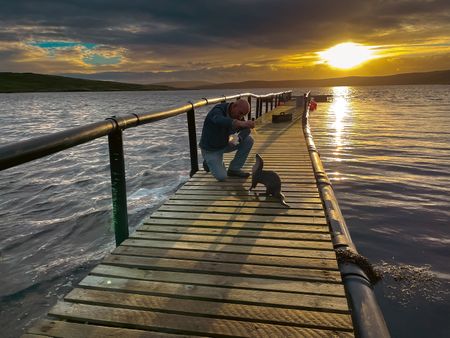 Billy and Molly on the pontoon at sunset. (National Geographic/Jeff Wilson)