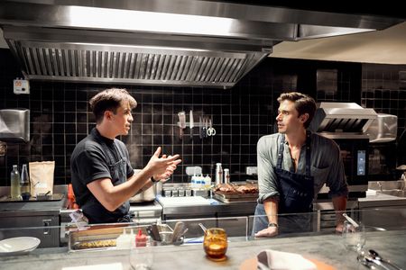 Victor Mercier, chef and owner of FIEF restaurant, chats with Antoni Porowski in the kitchen. (National Geographic/Amy Browning)