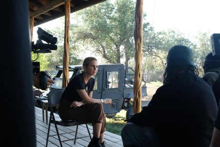Mariana van Zeller interviews El Gato, co-founder of the Black Cat Rifle Group, and another man. (National Geographic)