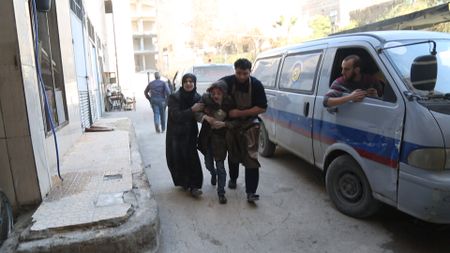 Al Ghouta, Syria - An injured girl is helped into the hospital for medical attention. (National Geographic)