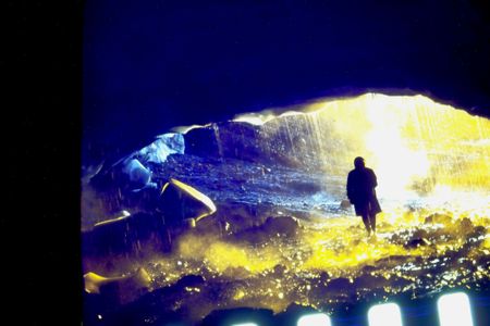 A silhouetted person stands beneath the vaulted ceiling of a glacial cave in Iceland. (Archival Materials Courtesy of Andri Sn&reg;r Magnason)