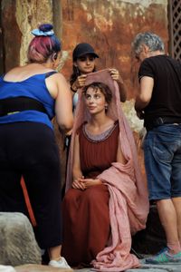 Madeleine Walker gets a hair and makeup touchup and costume adjustment, behind-the-scenes of Pompeii: Out of Time with Tom Hiddleston. (National Geographic/Darrin Zammit Lupi)