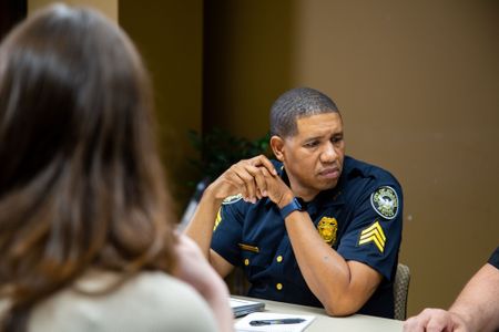 Sgt. Micheal Young, Atlanta Police Department, meets with Danielle and others to discuss the case. (National Geographic/Tom Beard)
