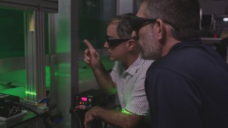 Professor Oscar M. Curet, expert, and Dr. Yannis Papastamatiou, expert, observing how a hydrofoil creates a vortex whilst travelling through the water. (National Geographic)