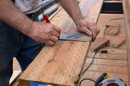 Terry Simpson helps repair a gangway. (National Geographic/Wes Waters)