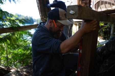 Carl Hernandez helps construct a ramp on his neighbor's property. (National Geographic/Mickey Ramos)