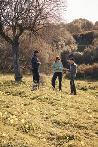TUCCI IN ITALY - “Sicily” - Director of Kolymbethra Federica Salvo, center, tours Stanley Tucci, right, through the huge garden where he meets with Rino Frenda, left, who is keeping a close eye on the almond trees. (National Geographic/Matt Holyoak)RINO FRENDA, FEDERICA SALVO, STANLEY TUCCI