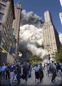 People flee the falling South Tower of the World Trade Center on September 11, 2001.  (AP Photo/Amy Sancetta)