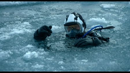 Expedition Leader and Oceanographer Allison Fong prepares to dive under the Arctic Ice in search of samples. (credit: National Geographic)
