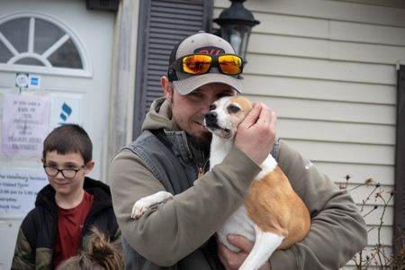 Jay is happy to be reunited with his dog Hank, after he was attacked by a muskrat and treated for his injuries. (National Geographic/Grace Sabwira)