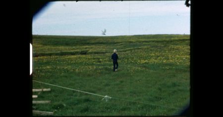 Little Andri in a field with glacier terns flying above him.   (credit: Archival Materials Courtesy of Andri Snþr Magnason)