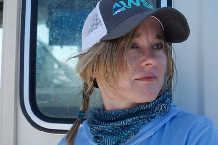 Dr. Megan Winton looks out to sea as the team wait for a bite on the line. (National Geographic/Brandon Sargeant)