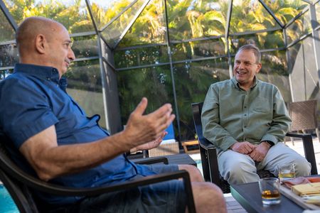 John McLoughlin chats with John Busching about the events of 9/11. Busching was one of the people who helped to rescue McLoughlin from the rubble of the World Trade Center. (National Geographic/Harrison Cooney)