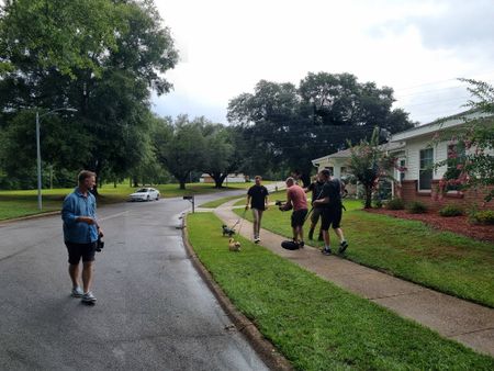 Director Chris Parkin, Student Spenser Neel, Camera Charlie Laing, and Sound Recordist Andy Paddon-Smith filming student LTJG Spenser Neel walking his dogs. (Credit: National Geographic/Evan Parker)
