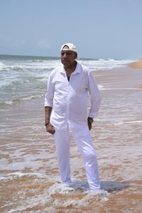 Garry Lumbers stands resolutely on Ouidah Beach, where his ancestor, Cudjo 'Kossola' Lewis, was taken in 1860. (National Geographic/Etinosa Yvonne)