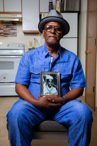 Chiam Bismillah Senior, father of the doe, holds a picture of his son, Kaif (birth name Keith Lavell Bibbs). (National Geographic/Tom Beard)