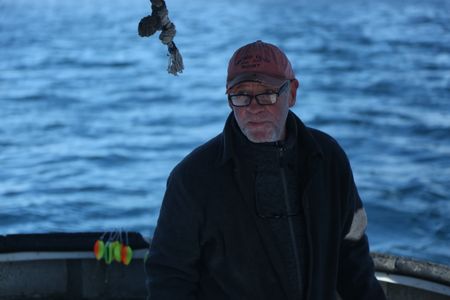 Sam Carlson fishes for salmon near the end of the summer troll season. (National Geographic/Wayne Moss)