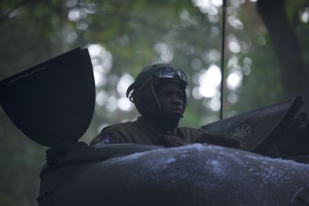 761st Black Panther Tank Battalion’s Tank Commander Johnnie Stevens (played by Juwon Adedokun) is pictured in a tank in a historic reenactment of the Battle of the Bulge produced for "Erased: WW2's Heroes of Color." Staff Sergeant Johnnie Stevens was a tank commander with the 761st Black Panther Tank Battalion who served in WW2. (National Geographic/Rekha Garton)