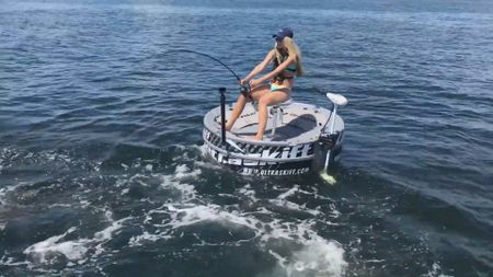 A shark steals a fish from a woman fishing off the Southeast Coast of Florida. (National Geographic)