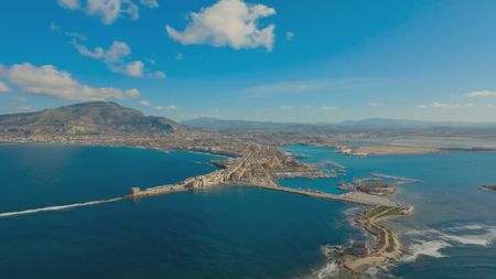 TUCCI IN ITALY - “Sicily” - Aerial view of Trapani’s old port with Mount Erice rising in the background. (National Geographic)TUCCI IN ITALY