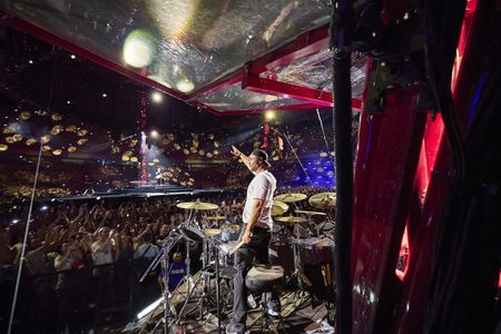 Chris Hemsworth drums during the Ed Sheeran concert in Bucharest. (credit: National Geographic/Evan Paterakis)