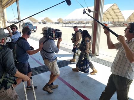 Assistant camera Dan Di Martino, sound recordist Nathan Kendall, Director Chris Parkin, DOP Jon Southgate-Sayers, instructor LCDR Kyle Westman, student Ashley Ross, and sound recordist Phil Bax filming the walk back from a jet. (National Geographic/Lyndsi Gutierrez)
