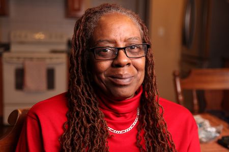 In September 2001, 42-year-old Daphne Carlisle had been working for the Port Authority as an Administrative Assistant for 7 months. She worked on the 82nd floor of the North Tower and loved her new job, but was frightened by the distance to the ground when she looked out her office window. When the first plane hit, she saw the shadow of the plane's wing as it approached the floors above her. (National Geographic/Daniel Bogado)