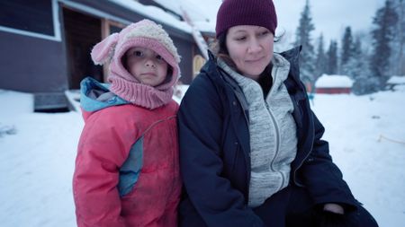 Sonta Roach with her daughter, Chevelle cooking a meal with her family outside their home. (BBC Studios/Dwayne Fowler )