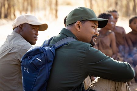 San Bushman Guide Kane Motswana, left, and Will Smith sit and talk with the San people in the Kalahari Desert.  (credit: National Geographic/Kyle Christy)