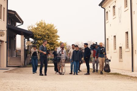 TUCCI IN ITALY - “Veneto” - Stanley Tucci and food writer Valeria Necchio with the crew outside of Italy's oldest working rice mill. (National Geographic/Matt Holyoak)VALERIA NECCHIO, STANLEY TUCCI