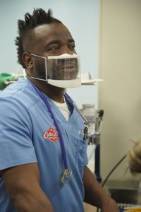 Dr. Hodges must take Lenny, the dog, into immediate surgery to remove his eye after being hit by a car. (National Geographic for Disney/Sean Grevencamp)