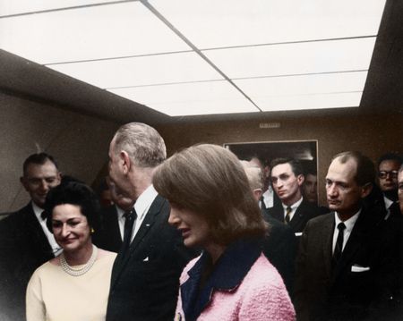 This colorized archival image shows the swearing-in ceremony of Lyndon B. Johnson (LBJ) as President aboard Air Force One with former first lady Jacqueline Kennedy standing next to him, Nov. 22, 1963, in Dallas. (Cecil Stoughton/White House Photographs/John F. Kennedy Presidential Library and Museum, Boston)