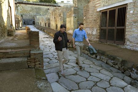 Dr. Darius Arya and Tom Hiddleston walk through the streets of Herculaneum. (National Geographic/Paolo Verzone)