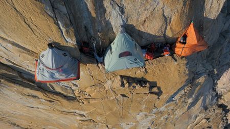 Aldo Kane peaks out from one of the tents on the pool wall. (photo credit: National Geographic/Matt Pyecroft)