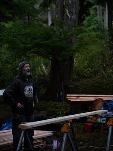 Dave Palmer helps build a cabin for his friend. (National Geographic/Robert Jolley)