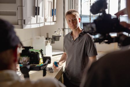 Director and Cinematographer, Adam Geiger, and Cinematographer, Rory McGuinnes, film Dr. C.E. O'Brien in the School for Field Studies lab in Turks and Caicos.   (National Geographic for Disney/Harriet Spark)