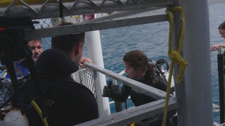 Experts Ryan Parker, Charlie Huveneers and Melissa Marquez discussing the aftermath of their recent dive to assess a large Great White shark in the water. (National Geographic/Jonathan Shaw)